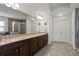 The Primary bathroom has double sinks, granite countertops, and tile flooring at 436 Barnett St, Woodstock, GA 30188