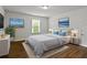 This spacious bedroom features a large window, wood floors, and cool artwork at 436 Barnett St, Woodstock, GA 30188