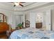The bedroom features dark wood flooring, neutral walls, and a view into the adjoining bathroom at 436 Barnett St, Woodstock, GA 30188