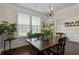 Elegant dining room with hardwood floors, featuring a chandelier and large windows for ample natural light at 436 Barnett St, Woodstock, GA 30188