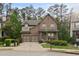Charming brick home featuring a well-manicured lawn, attached two-car garage, and inviting covered front porch at 436 Barnett St, Woodstock, GA 30188