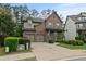 Frontal view of a charming brick home with attached two-car garage and manicured lawn and shrubbery at 436 Barnett St, Woodstock, GA 30188