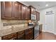 Kitchen features stainless steel appliances, granite countertops, and wood cabinets at 436 Barnett St, Woodstock, GA 30188