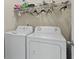 Practical laundry room with side-by-side washer and dryer, and shelving at 436 Barnett St, Woodstock, GA 30188