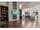 Open-concept living room with a stone fireplace, built-in shelves, and dark hardwood floors at 436 Barnett St, Woodstock, GA 30188
