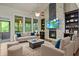 Spacious living room with soaring ceilings, fireplace, hardwood floors, and a comfortable seating arrangement at 436 Barnett St, Woodstock, GA 30188