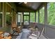 Relaxing screened porch with comfortable seating and a view of lush greenery at 436 Barnett St, Woodstock, GA 30188