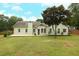 Back exterior view of the home showcasing the patio and backyard at 47 Cliff Ct, Villa Rica, GA 30180