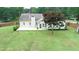 Aerial view of fenced backyard with patio and mature landscaping at 47 Cliff Ct, Villa Rica, GA 30180