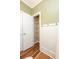 Bathroom showing linen closet and tub-shower combo, with white wainscotting, and luxury vinyl plank flooring at 47 Cliff Ct, Villa Rica, GA 30180