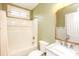 Bathroom showcasing a tub-shower combination, marble vanity, updated fixtures, and neutral green walls at 47 Cliff Ct, Villa Rica, GA 30180
