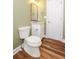 Updated half bath features a tile floor, green walls, modern fixtures, and a paneled door at 47 Cliff Ct, Villa Rica, GA 30180