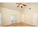 Spacious bedroom with vaulted ceiling, ceiling fan, carpet, and patio access at 47 Cliff Ct, Villa Rica, GA 30180