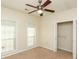 Bright bedroom featuring neutral walls, carpet flooring, ceiling fan, and closet with organizers at 47 Cliff Ct, Villa Rica, GA 30180
