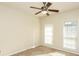 Bright bedroom featuring neutral walls, carpet flooring, ceiling fan, and large windows with blinds at 47 Cliff Ct, Villa Rica, GA 30180