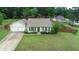 Aerial shot of home with mature landscaping, large front yard, and attached garage at 47 Cliff Ct, Villa Rica, GA 30180