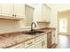 Close up of kitchen sink with stainless dishwasher, wood cabinets, and wood flooring at 47 Cliff Ct, Villa Rica, GA 30180