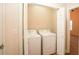 A laundry room with white front load machines and views to bedroom at 47 Cliff Ct, Villa Rica, GA 30180