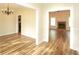 Bright living room with hardwood floors, white trim, and a glimpse of the fireplace at 47 Cliff Ct, Villa Rica, GA 30180