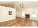 Open living room with fireplace, hardwood floors, and views to kitchen at 47 Cliff Ct, Villa Rica, GA 30180