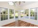 Bright sunroom featuring wood floors, large windows, and backyard views at 47 Cliff Ct, Villa Rica, GA 30180