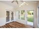 Bright sunroom with wood floors, ceiling fan, large windows, and access to the backyard at 47 Cliff Ct, Villa Rica, GA 30180