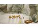 Elegant bathroom featuring a gold faucet, marble countertop, and stylish wallpaper at 541 Londonberry Rd, Atlanta, GA 30327