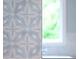 A close-up shot of a bathroom design highlighting floral patterned tilework and a glimpse of greenery through the window at 541 Londonberry Rd, Atlanta, GA 30327