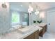 Bright bathroom featuring double vanity, marble countertop, vessel sinks, and a soaking tub with a window view at 541 Londonberry Rd, Atlanta, GA 30327