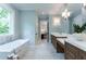 Bright bathroom with double vanity, a soaking tub, and modern finishes at 541 Londonberry Rd, Atlanta, GA 30327