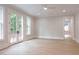 Bright bedroom with hardwood floors, neutral paint, and French doors at 541 Londonberry Rd, Atlanta, GA 30327