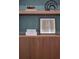 Close up of wood built-ins with textured wallpaper insets and a variety of decorative items at 541 Londonberry Rd, Atlanta, GA 30327