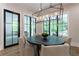 Cozy dining area with modern lighting fixture and large windows overlooking backyard at 541 Londonberry Rd, Atlanta, GA 30327