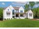 Stunning white brick home with a lush green lawn and manicured landscaping at 541 Londonberry Rd, Atlanta, GA 30327