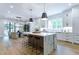 Bright kitchen with a large marble island, stainless steel appliances, and breakfast bar at 541 Londonberry Rd, Atlanta, GA 30327