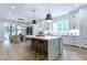 Modern kitchen with a marble island, stylish pendant lights, and stainless steel appliances at 541 Londonberry Rd, Atlanta, GA 30327