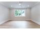 Living room features hardwood floors, a window view to the backyard, recessed lights, and crown molding at 541 Londonberry Rd, Atlanta, GA 30327