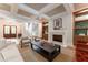 Elegant living room with coffered ceilings, fireplace, built-ins and natural light from the front door at 541 Londonberry Rd, Atlanta, GA 30327