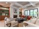 Bright living room with modern furnishings, fireplace, built-ins, and seamless access to outdoor living at 541 Londonberry Rd, Atlanta, GA 30327