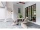 Outdoor dining area with brick floors and walls, featuring a round table and modern chairs at 541 Londonberry Rd, Atlanta, GA 30327