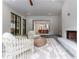 A covered outdoor porch is furnished with a sitting area and a gas fireplace at 541 Londonberry Rd, Atlanta, GA 30327