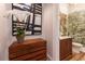 Powder room with decorative wallpaper, wooden dresser and modern artwork at 541 Londonberry Rd, Atlanta, GA 30327