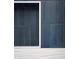 A stylish shower showcasing a built-in niche with deep blue vertical tiles and textured white floor tiles at 541 Londonberry Rd, Atlanta, GA 30327