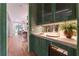 Green wet bar featuring elegant cabinetry, marble countertop, designer hardware and a beverage refrigerator at 541 Londonberry Rd, Atlanta, GA 30327