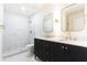 Modern bathroom featuring double sinks, marble countertops, gold fixtures, and a tiled shower at 6109 Park Ave, Atlanta, GA 30342