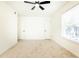Neutral bedroom featuring a ceiling fan, window and two closet doors at 6109 Park Ave, Atlanta, GA 30342