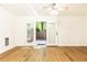 Living room with hardwood floors, ceiling fan, and glass doors opening to the backyard at 6109 Park Ave, Atlanta, GA 30342