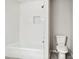 Clean bathroom showcasing a tiled shower-tub combination and modern toilet at 6549 Biscayne Way, Douglasville, GA 30135