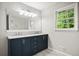 Well-lit bathroom with dual sinks, modern vanity, and a large mirror, offering a functional space at 6549 Biscayne Way, Douglasville, GA 30135