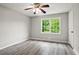 Bright bedroom with large window, ceiling fan, and modern gray vinyl floors at 6549 Biscayne Way, Douglasville, GA 30135